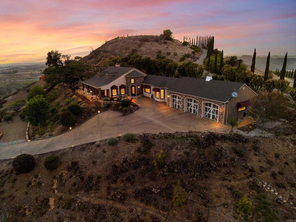 Sunset aerial of the hilltop estate at 30419 Canyon Estates Road, Vista