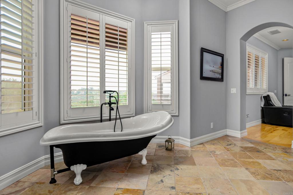 Spa inspired primary bath with clawfoot soaking tub